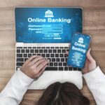 Mulher usando laptop e smartphone para login em um aplicativo de online banking. Acesso digital rápido para sua liberdade financeira.